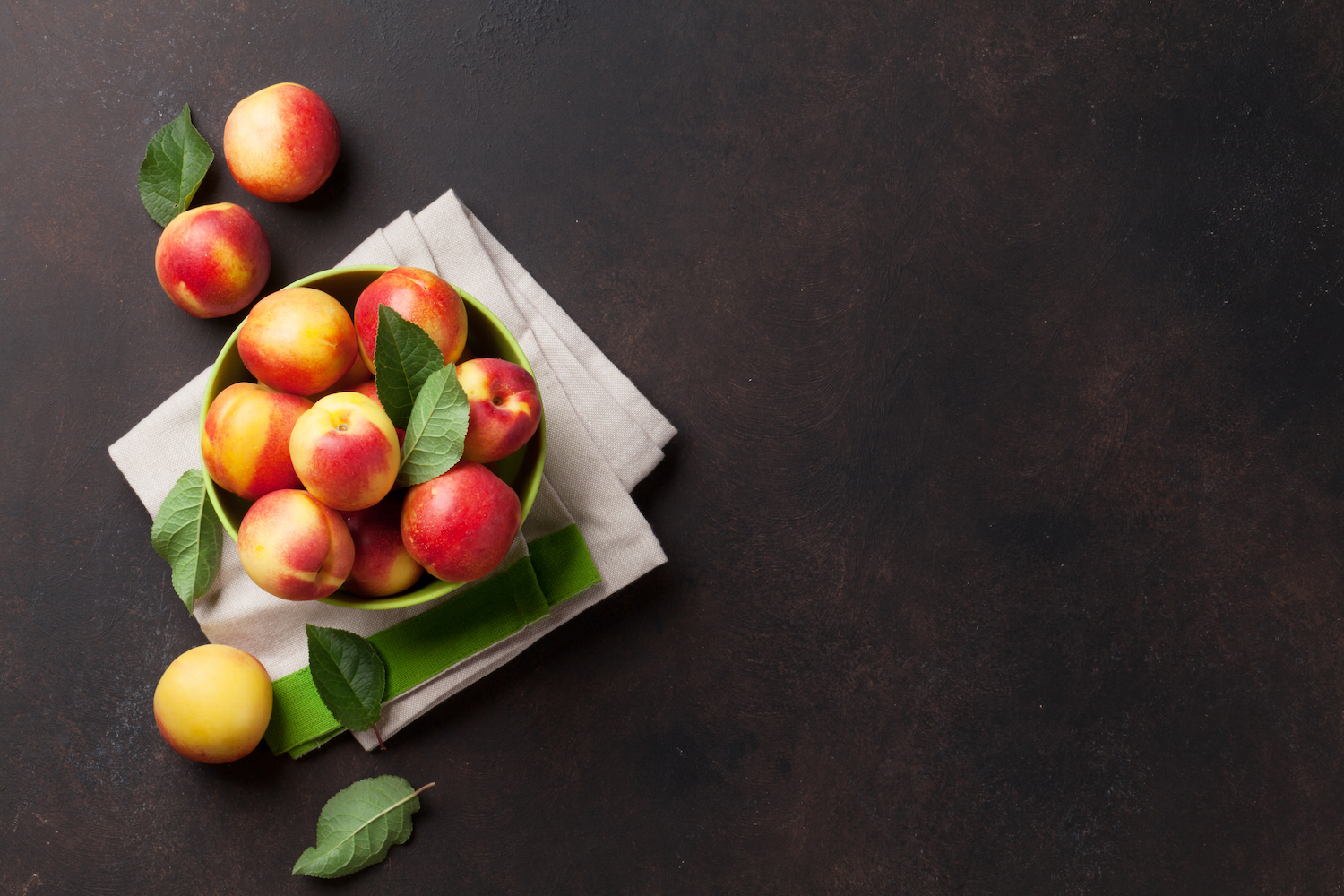 Fresh ripe peaches on stone table. Top view with space for your text
