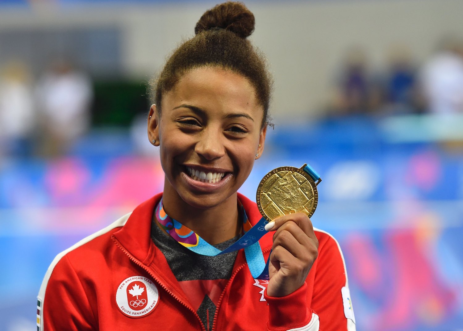 Canada's diver Jennifer Abel celebrates on the podium with her gold medal after winning the Diving Women's 3m Springboard Final of the Lima 2019 Pan-American Games at the Aquatic Centre in Lima on August 5, 2019. (Photo by Pedro PARDO / AFP)        (Photo credit should read PEDRO PARDO/AFP via Getty Images)