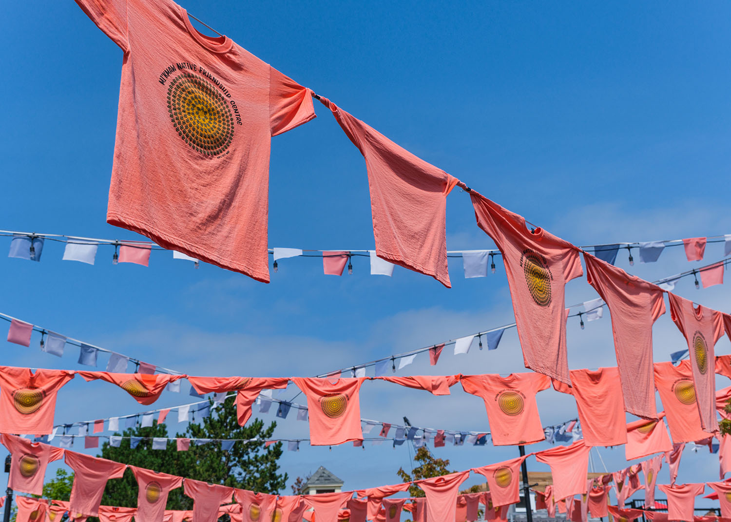 Halifax, Nova Scotia, Canada - 10 August 2021: Orange shirts hang at the Halifax waterfront to honour Indigenous children forcibly taken to residential schools
