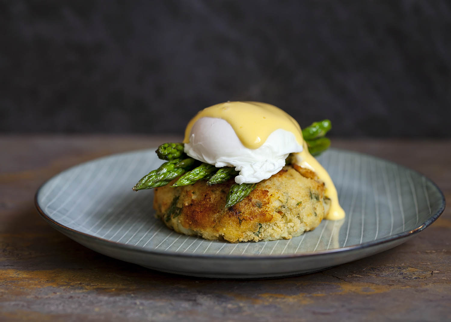 Fish cake with asparagus, poached egg and hollandaise sauce