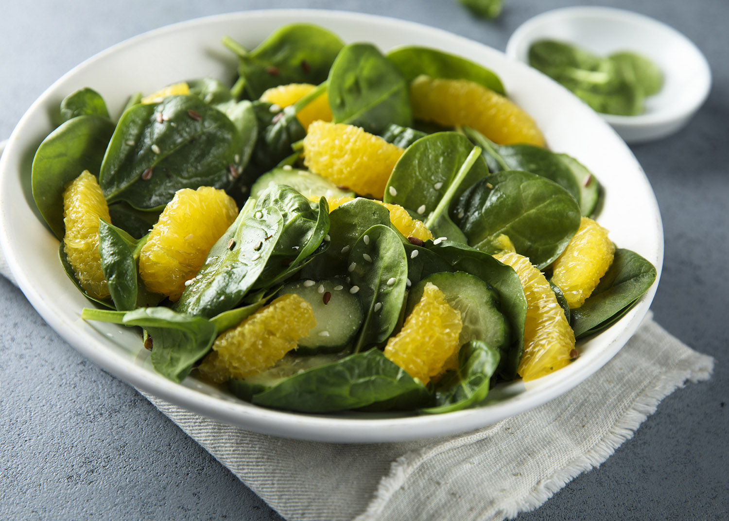 Healthy spinach salad with orange and cucumber