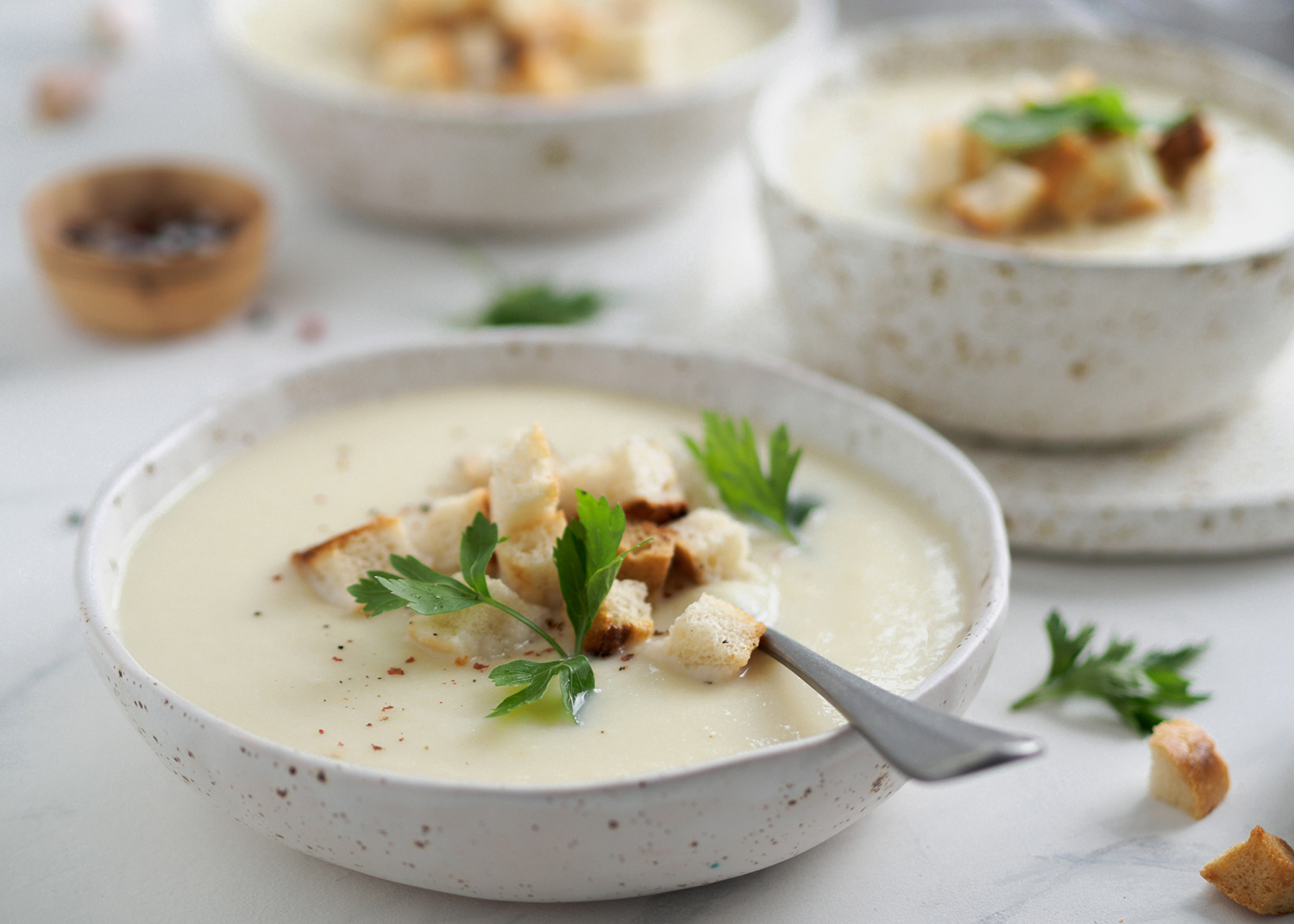 cauliflower potato soup puree on white marble tabletop, Creamy cauliflower soup with toasted bread croutons. Vegetarian healthy food concept. Ideas and recipes for winter meal. Copy space