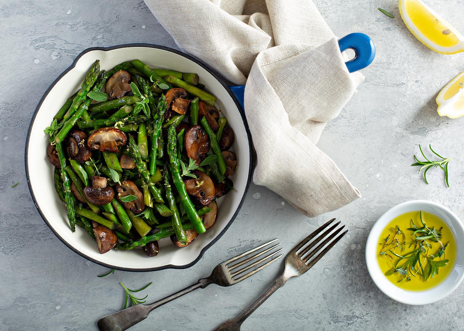 Asparagus and mushrooms sauteed in a cast iron pan with lemon zest