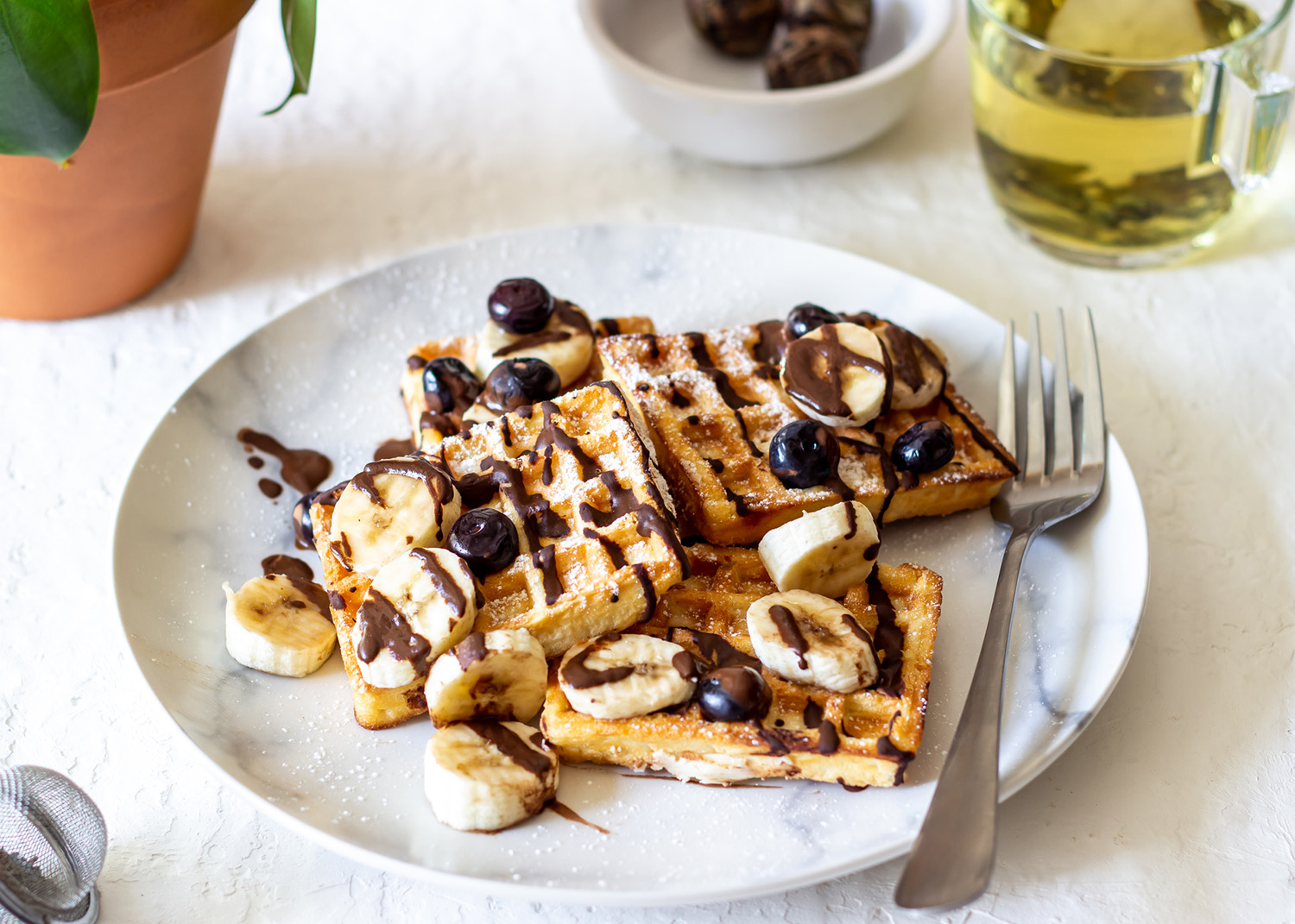 Belgian waffles with blueberries and bananas. National cuisine. Dessert. Recipes.