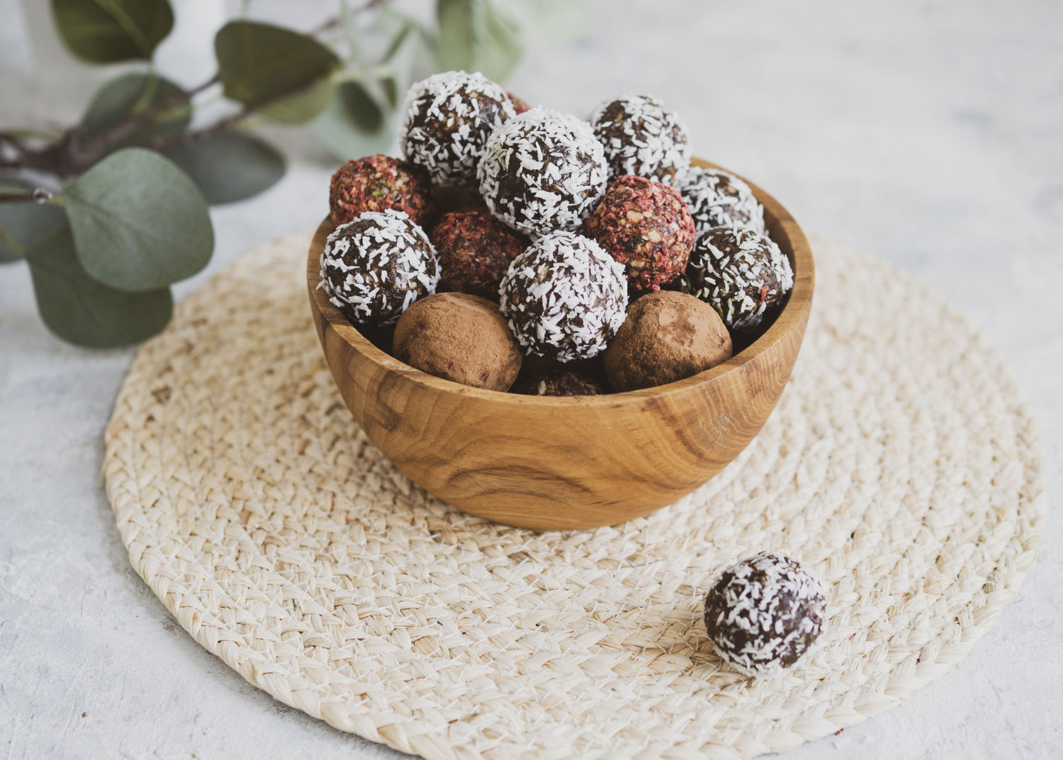set of energy balls on a light table, bowl. Homemade healthy sweets