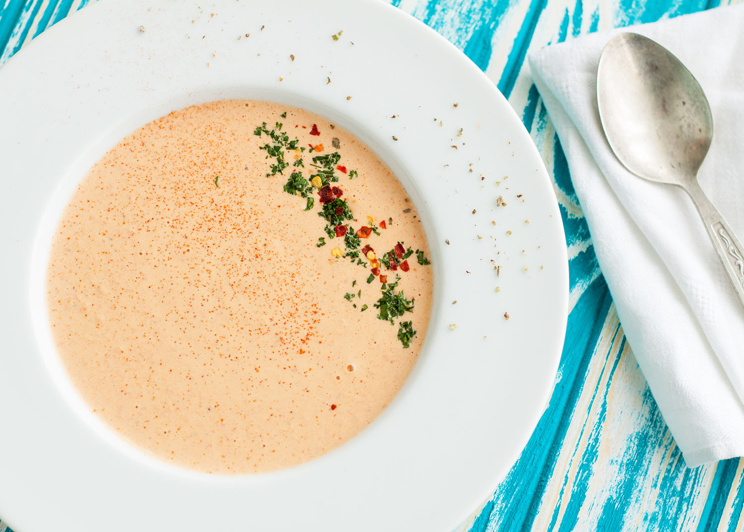 Creamy crab soup bisque with spices on wooden table