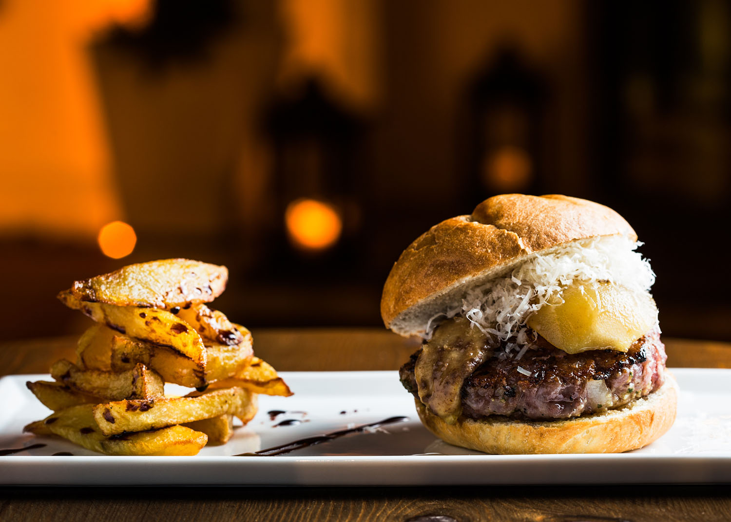 Grilled burger with foie grass, pear, cheese and fries.