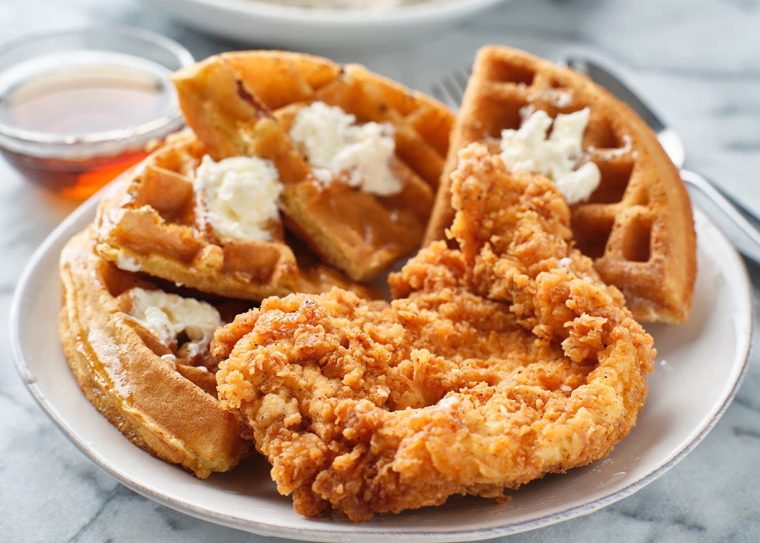 fried chicken and waffles breakfast with maple syrup