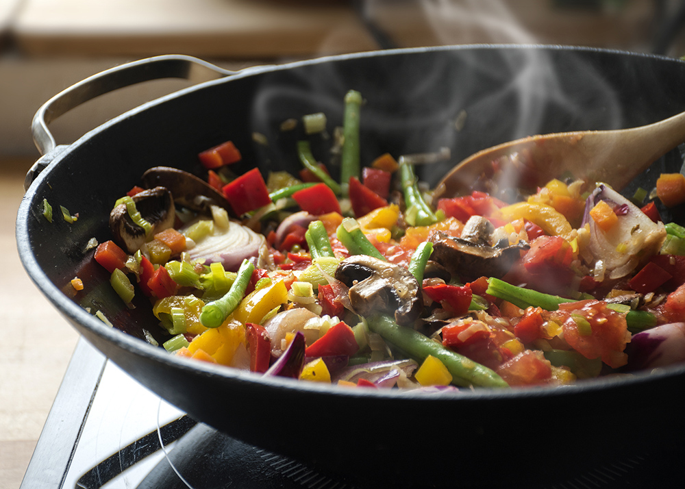 steaming mixed vegetables in the wok, asian style cooking vegetarian and healthy, selected focus, narrow depth of field