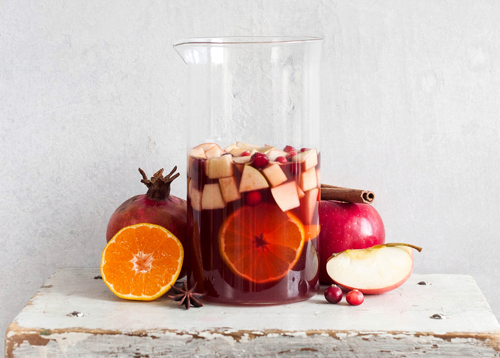 Sangria with apples, cranberries and orange in a bottle