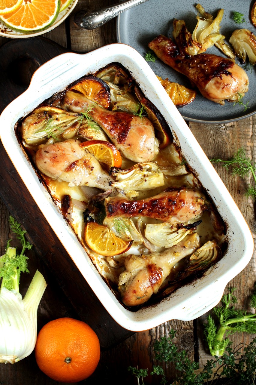 dish with fennel. Baked chicken drumsticks with fennel and oranges. festive dish, popular in the Mediterranean. Keto diet dish. ceramic baking dish. top view. Flatlay
