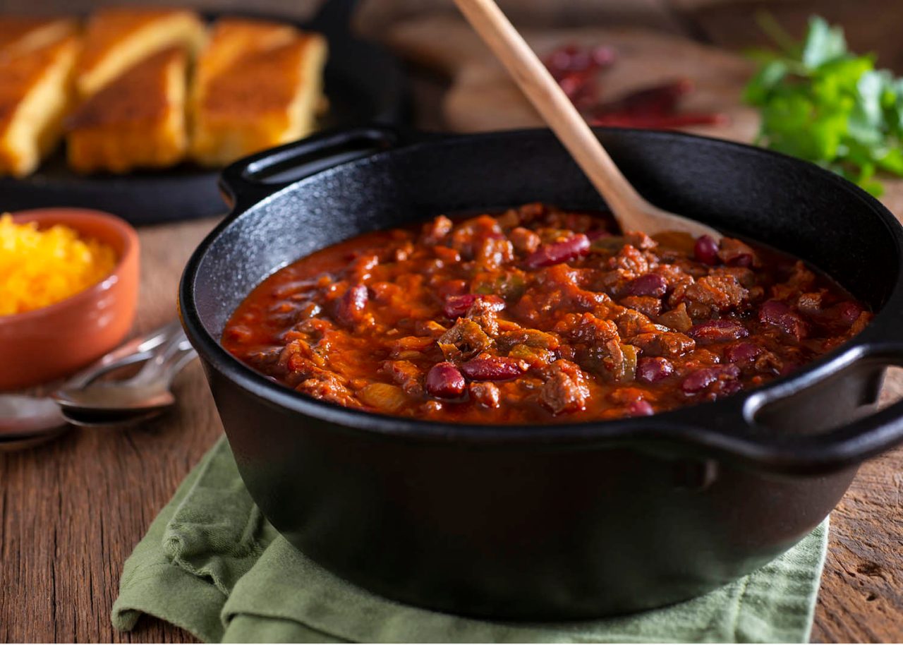Classic Southwestern Chili in a Cast Iron Dutch Oven with Corn Bread and Cheddar Cheese
