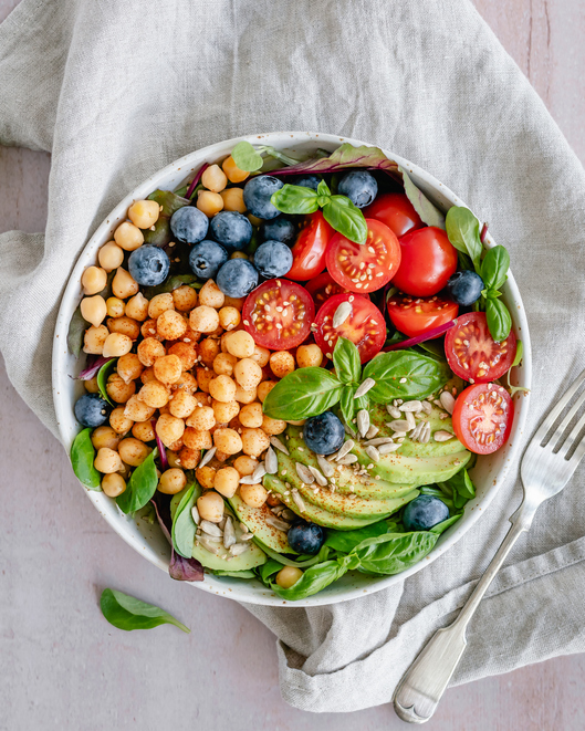 Overhead view of a bowl of colorful vegan chickpea salad