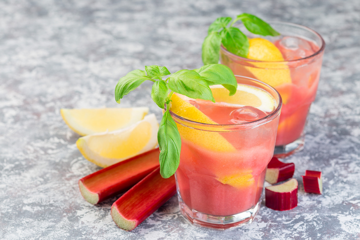 Refreshing lemonade with rhubarb, lemon, sparkling water and basil in  glass, horizontal, copy space