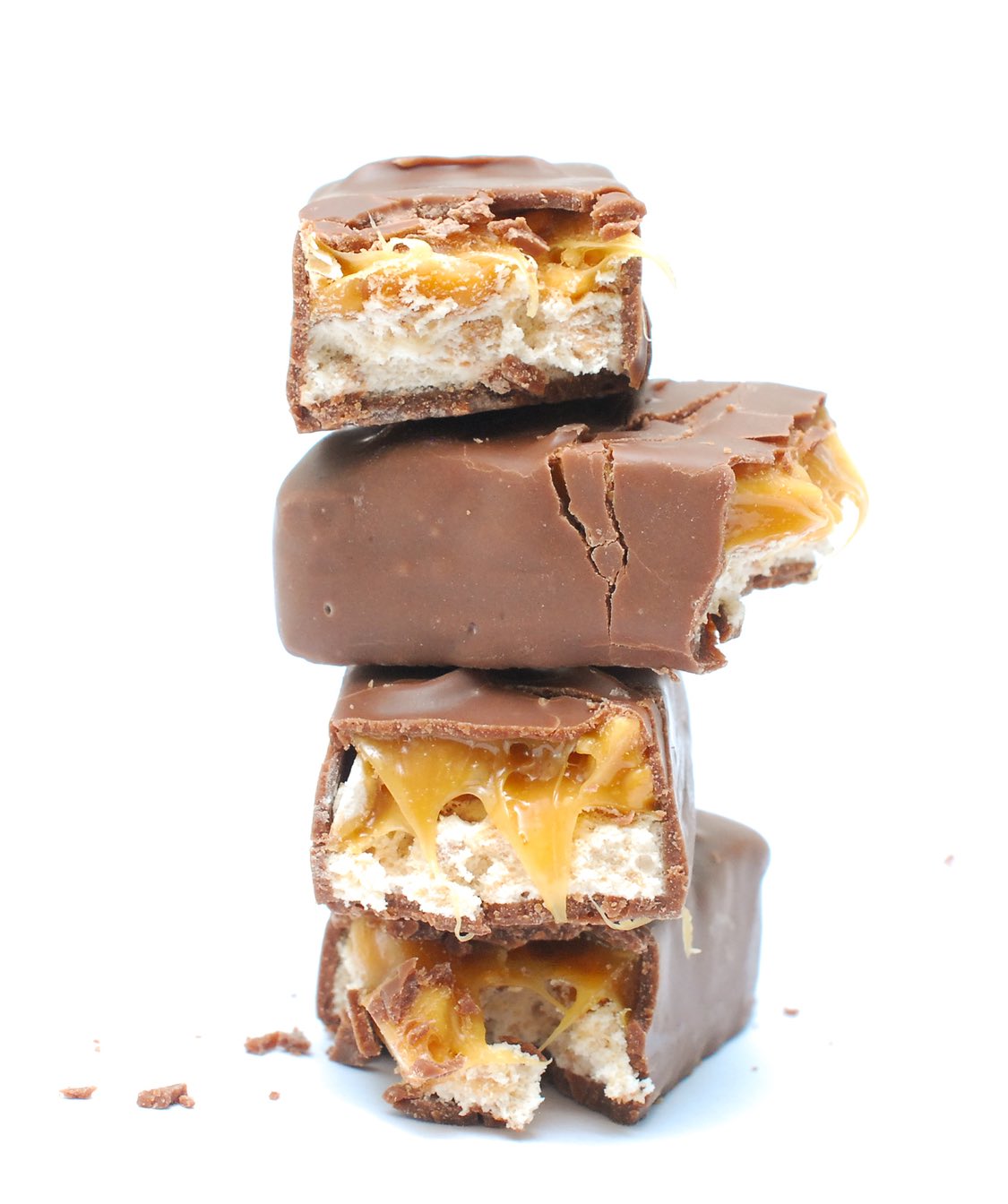 chocolate and nuts energy bar on white close up photography