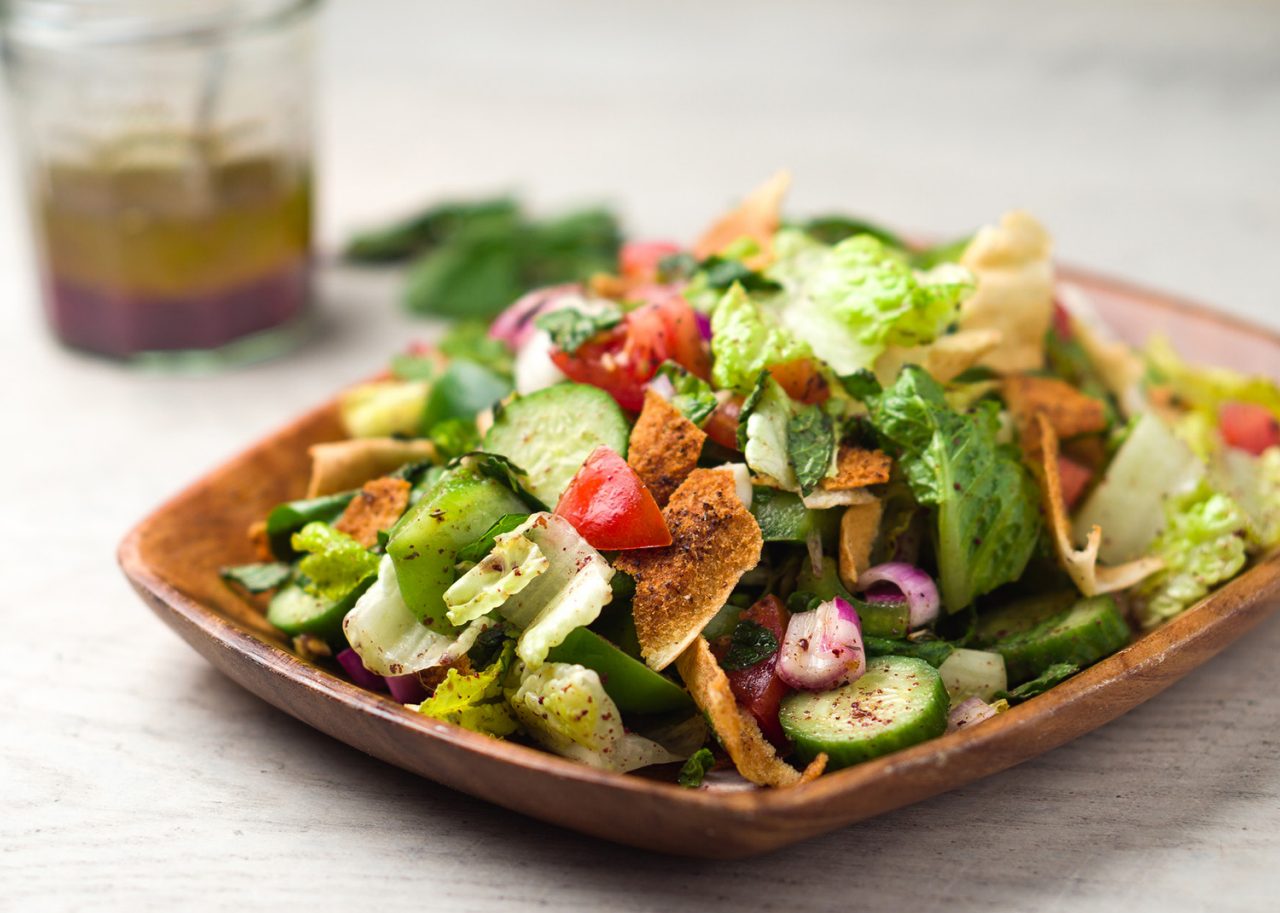 Vegetarian fattoush salad lunch. The key ingredient in this middle eastern dish is the toasted pita bread which is mixed with healthy vegetables, herbs and a dressing made with lemon and sumac.