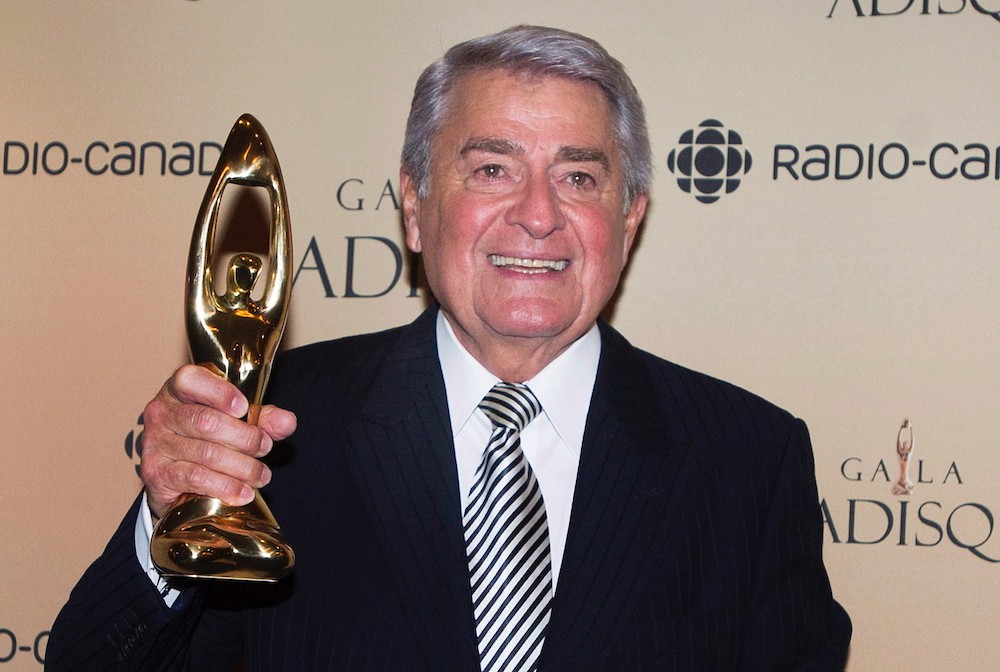 Michel Louvain holds up his Felix honorary award at the gala Adisq awards ceremony in Montreal, Sunday, October 26, 2014. THE CANADIAN PRESS/Graham Hughes