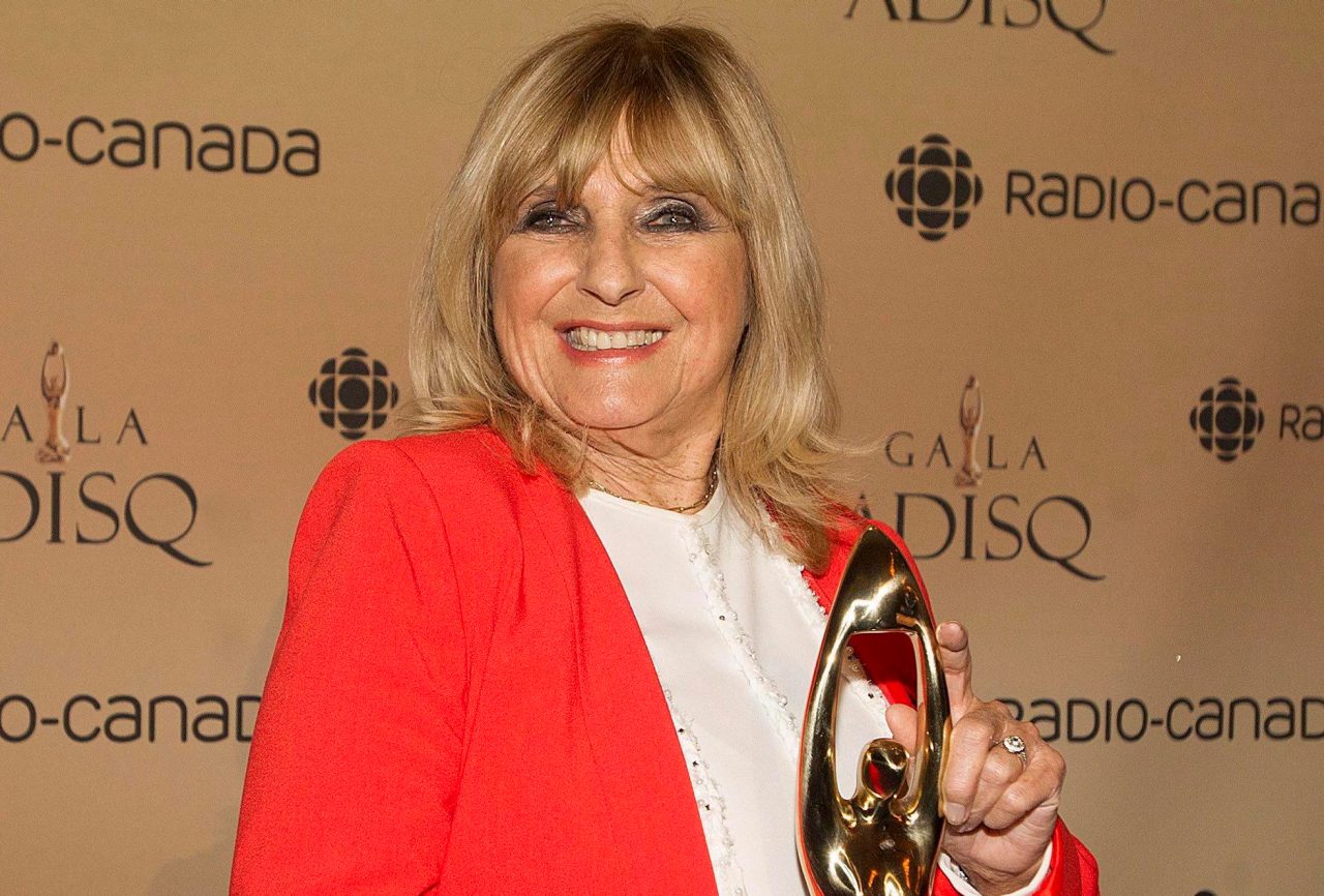Dominique Michel holds up her honor award at the annual Gala Adisq awards ceremony in Montreal Sunday, November 8, 2015. THE CANADIAN PRESS/Graham Hughes