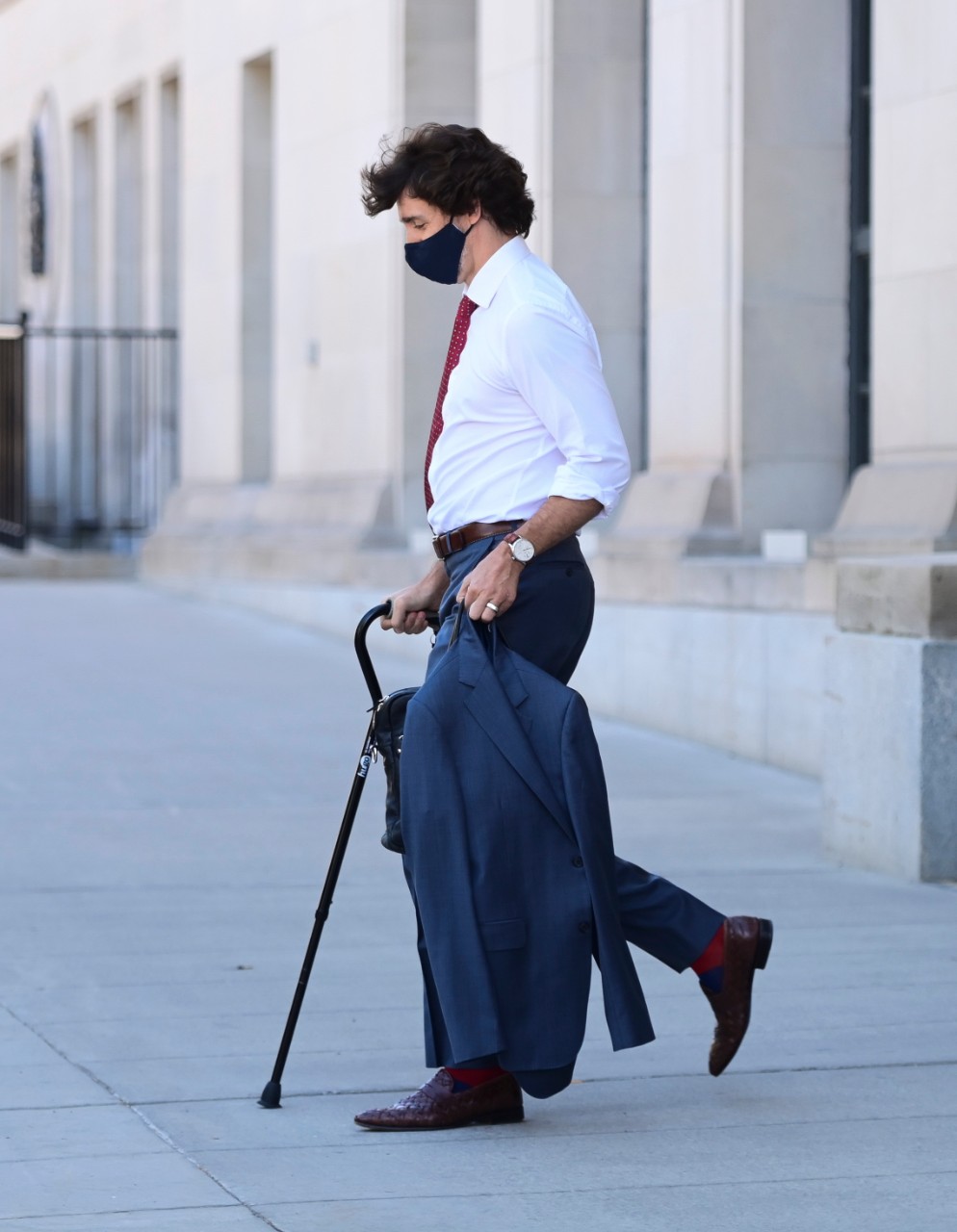 Prime Minister Justin Trudeau walks with a cane as he leaves a news conference in Ottawa on Monday, May 31, 2021. THE CANADIAN PRESS/Sean Kilpatrick
