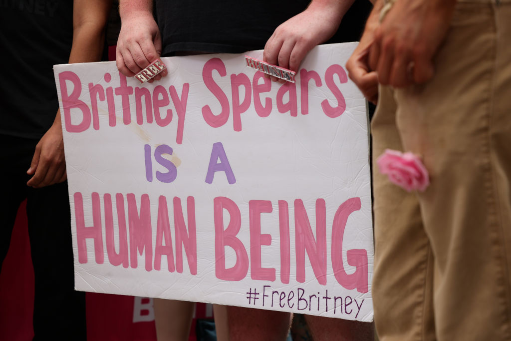 LOS ANGELES, CALIFORNIA - JUNE 23: #FreeBritney activists protest at Los Angeles Grand Park during a conservatorship hearing for Britney Spears on June 23, 2021 in Los Angeles, California. Spears is expected to address the court remotely.  Spears was placed in a conservatorship managed by her father, Jamie Spears, and an attorney, which controls her assets and business dealings, following her involuntary hospitalization for mental care in 2008. (Photo by Rich Fury/Getty Images)