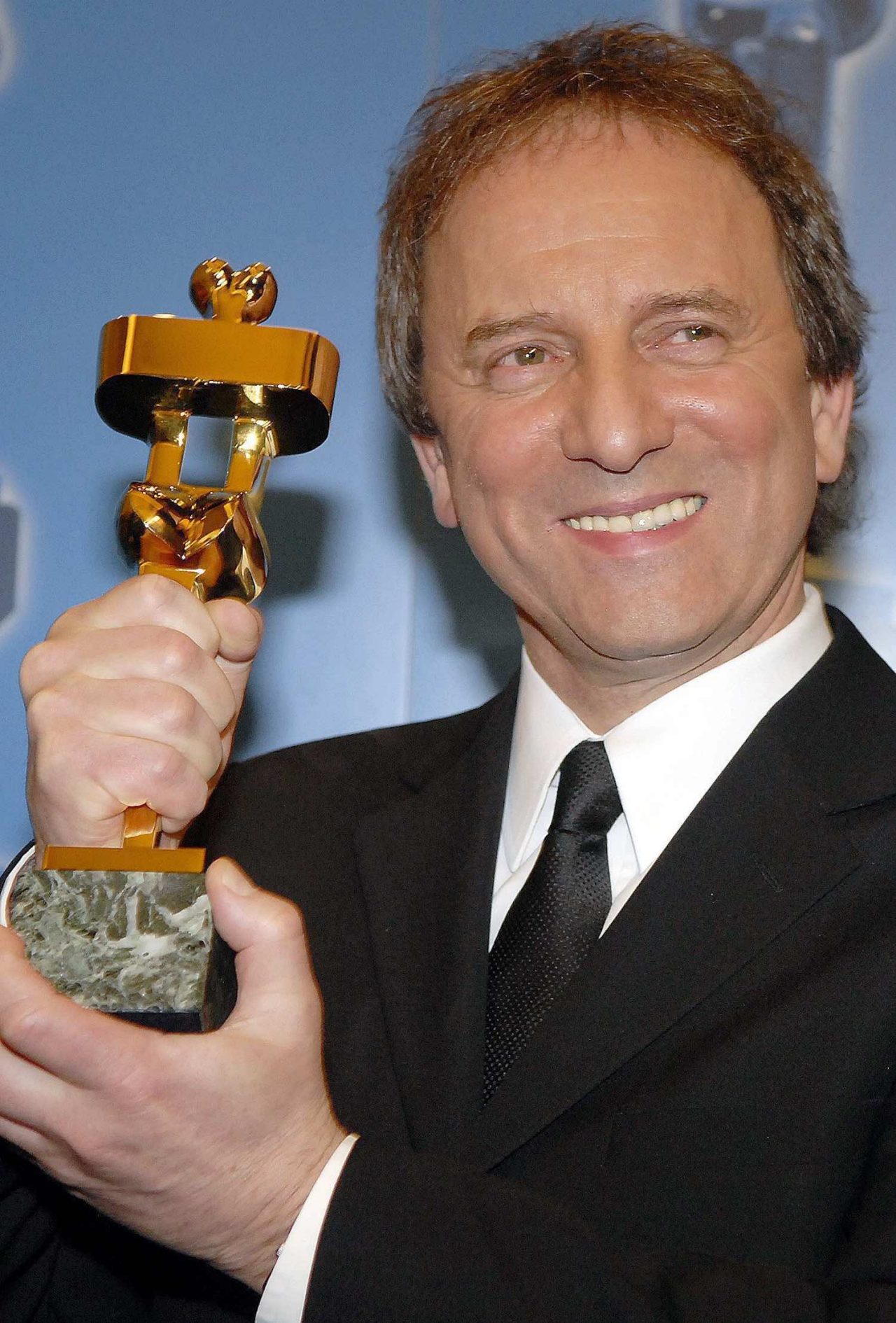 Actor Michel Cote poses for photographers at the 26th Annual Genie Awards in Toronto Monday, March 13, 2006. Cote won for best performance by an actor in a leading role in C.R.A.Z.Y. (CP PHOTO/Aaron Harris)