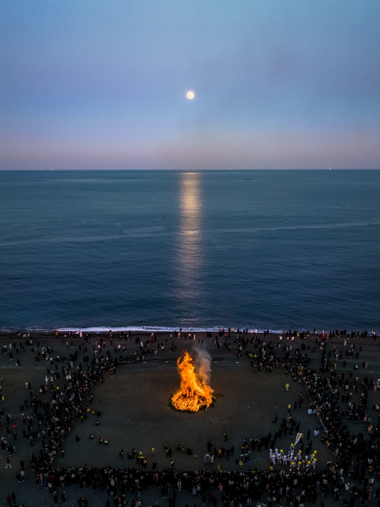 Daeboreum is a Korean holiday that celebrates the first full moon of the new year of the lunar calendar. Setting a large â ³moon houseâ ³ on fire is a Jeongwol Daeboreum custom to ward off bad luck. 

Jeongja Beach, Buk-gu, Ulsan, South Korea.