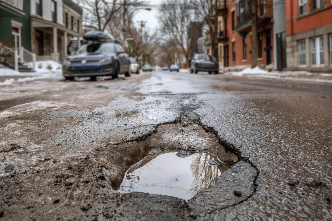 Large deep pothole in Montreal street, Canada.