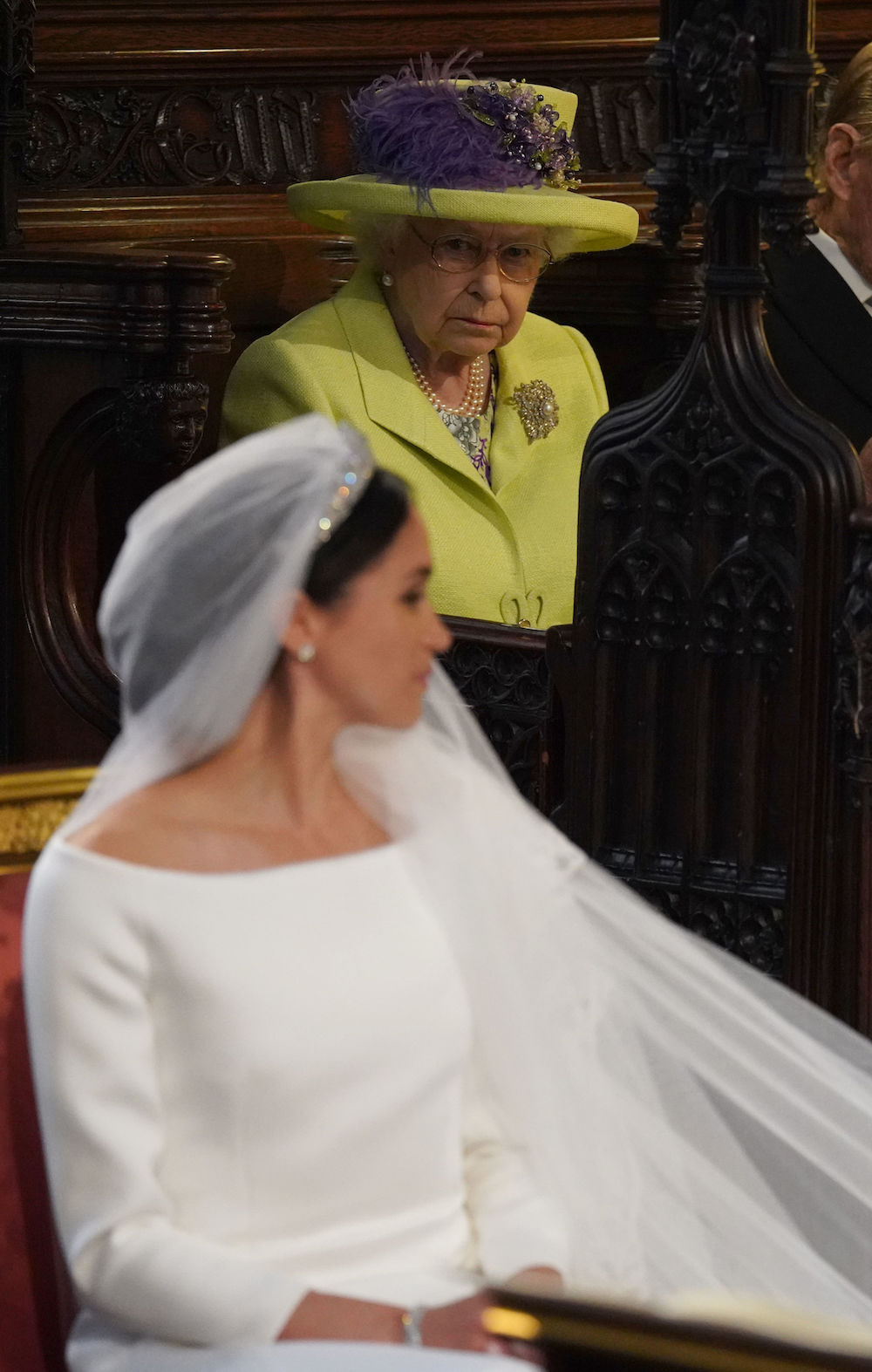 TOPSHOT - Britain's Queen Elizabeth II looks on during the wedding ceremony of Britain's Prince Harry, Duke of Sussex and US actress Meghan Markle in St George's Chapel, Windsor Castle, in Windsor, on May 19, 2018. (Photo by Jonathan Brady / POOL / AFP)        (Photo credit should read JONATHAN BRADY/AFP via Getty Images)