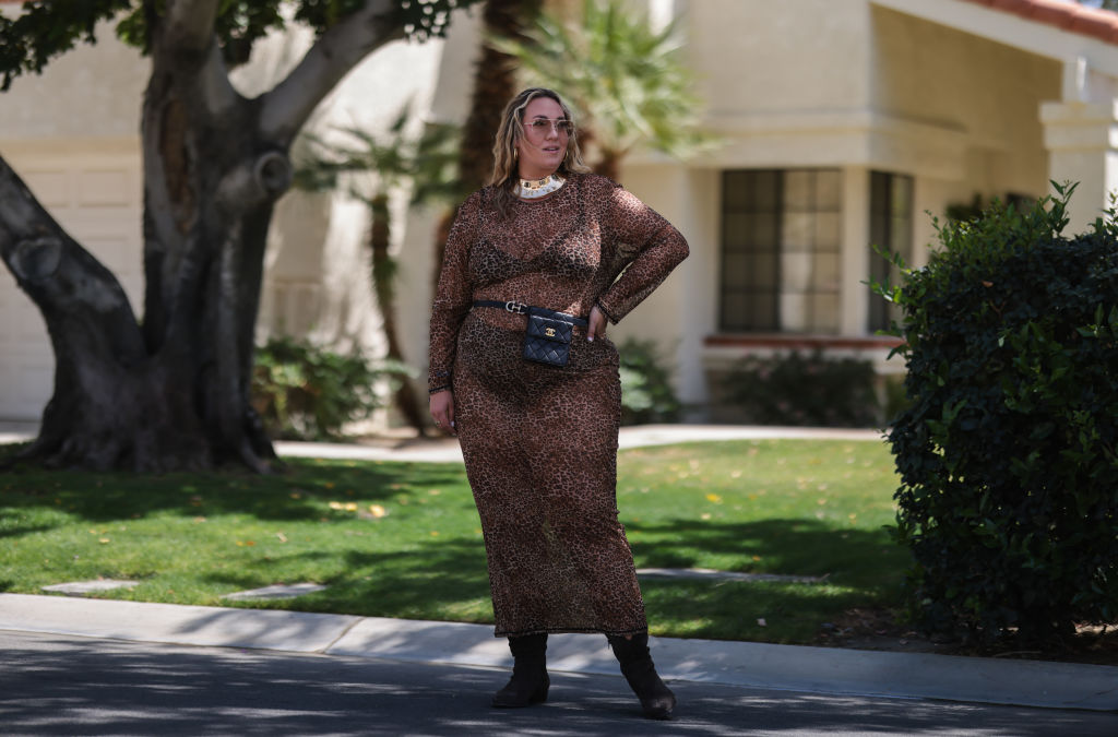 INDIO, CALIFORNIA - APRIL 16: Verena Prechtl seen wearing a brown sunglasses, a gold statement necklace, a brown transparent  leo print maxi dress, a black leather belt bag from Chanel, brown suede leather cowboy boots on April 16, 2022 in Indio, California. (Photo by Jeremy Moeller/Getty Images)
