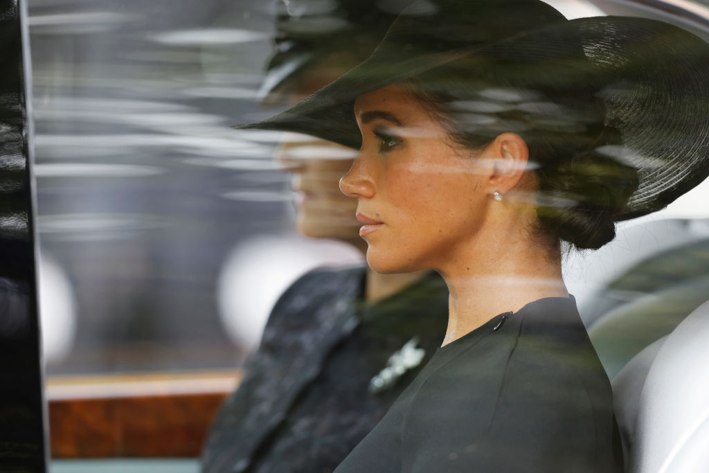 LONDON, ENGLAND - SEPTEMBER 19: Meghan, Duchess of Sussex is driven down The Mall after the funeral for HM Queen Elizabeth II's funeral on September 19, 2022 in London, England. Elizabeth Alexandra Mary Windsor was born in Bruton Street, Mayfair, London on 21 April 1926. She married Prince Philip in 1947 and ascended the throne of the United Kingdom and Commonwealth on 6 February 1952 after the death of her Father, King George VI. Queen Elizabeth II died at Balmoral Castle in Scotland on September 8, 2022, and is succeeded by her eldest son, King Charles III.  (Photo by Tom Jenkins - WPA Pool/Getty Images)