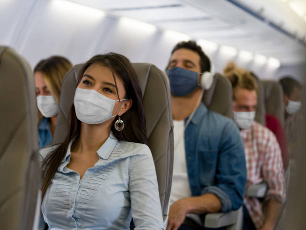 Portrait of a Latin American Woman traveling by plane wearing a facemask during the COVID-19 pandemic