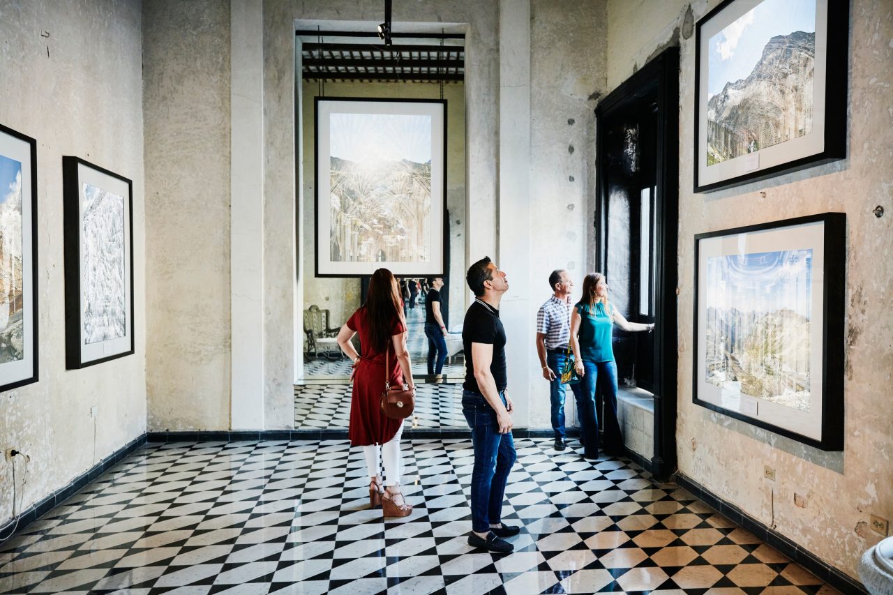Two couples admiring artwork in museum while on vacation